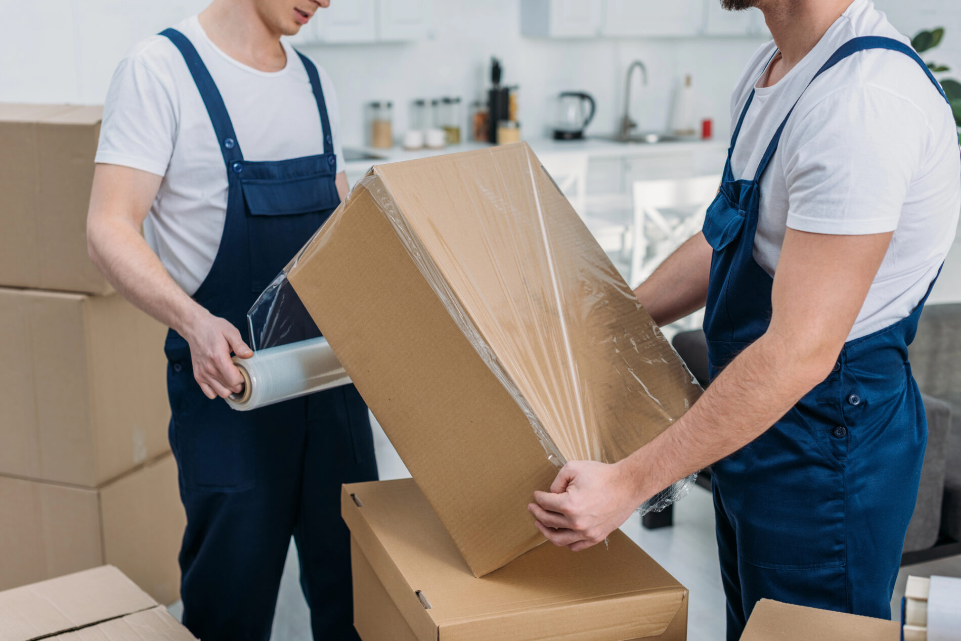 Moving company preparing boxes.